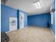 Room shows blue walls, tiled floors, and a door to a staircase at 305 Meadowlark Ln, Moncks Corner, SC 29461