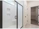 Bathroom featuring black framed shower door, built-in shelves, white tiled walls and walk-in closet at 306 O'Malley Dr, Summerville, SC 29483