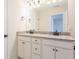 Bathroom showcasing double sinks, granite countertops, framed mirror, bronze accents, and tiled floor at 306 O'Malley Dr, Summerville, SC 29483