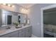 Stylish bathroom with double vanity, framed mirror, and a doorway into the main bedroom at 306 O'Malley Dr, Summerville, SC 29483