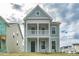 Charming two-story home featuring light green siding, white trim and a cozy second story balcony at 306 O'Malley Dr, Summerville, SC 29483