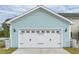Charming garage features light blue siding, carriage door, and carriage-style lighting at 306 O'Malley Dr, Summerville, SC 29483