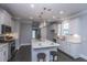 Bright kitchen features white cabinets, stainless steel appliances, and a center island with seating at 306 O'Malley Dr, Summerville, SC 29483