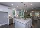 Modern kitchen with white cabinets, stainless steel appliances, a large island and wood flooring at 306 O'Malley Dr, Summerville, SC 29483