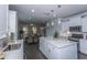 Bright kitchen with white cabinets, stainless appliances and a large island with a white countertop at 306 O'Malley Dr, Summerville, SC 29483