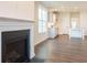 Bright living room features a fireplace, wood flooring, and an open floor plan with kitchen view at 306 O'Malley Dr, Summerville, SC 29483
