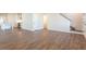 Spacious living room shows wood-look floors with a view of the kitchen and staircase at 306 O'Malley Dr, Summerville, SC 29483