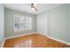 Cozy bedroom with hardwood floors, ceiling fan, and plantation shutters at 3066 Penny Ln, Johns Island, SC 29455