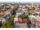 Scenic aerial view showcasing a vibrant neighborhood with colorful houses and lush trees at 32 Tradd St, Charleston, SC 29401