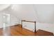 Bright attic space with hardwood floors, sloped ceilings, and white walls and staircase at 32 Tradd St, Charleston, SC 29401