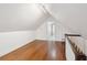 Bright attic space with hardwood floors, sloped ceilings, and white walls at 32 Tradd St, Charleston, SC 29401