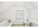 Bright white bathroom with white appliances, a tub, and a window at 32 Tradd St, Charleston, SC 29401