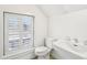 Bright white bathroom with white appliances, a sink, and a window at 32 Tradd St, Charleston, SC 29401