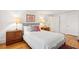 Well-lit bedroom with hardwood floors, comfortable bed, and stylish bedside tables at 32 Tradd St, Charleston, SC 29401