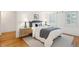 Well-lit bedroom features hardwood floors, a comfortable bed, and stylish bedside lamps at 32 Tradd St, Charleston, SC 29401