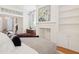 Comfortable bedroom features a decorative fireplace and access to other rooms in the home at 32 Tradd St, Charleston, SC 29401