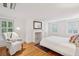 Inviting bedroom with a chair, fireplace, and hardwood floors at 32 Tradd St, Charleston, SC 29401