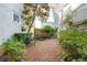 Secluded courtyard with brick pavement, lush greenery, and a tranquil fountain at 32 Tradd St, Charleston, SC 29401