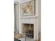 A classic fireplace is framed by a white mantel and features neutral decor at 32 Tradd St, Charleston, SC 29401