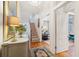 Sunlit foyer features wood floors, an elegant console, and access to the living room at 32 Tradd St, Charleston, SC 29401