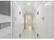 Hallway with white wooden floor, white walls, and many storage closets at 32 Tradd St, Charleston, SC 29401