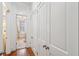 Hallway with built-in closets leads to a bright bathroom with a soaking tub at 32 Tradd St, Charleston, SC 29401