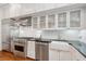 Renovated kitchen with stainless appliances, white cabinets, and dark countertops at 32 Tradd St, Charleston, SC 29401