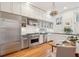 Modern kitchen with stainless steel appliances, white cabinets, and hardwood floors at 32 Tradd St, Charleston, SC 29401