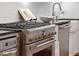 Close up of stainless steel oven and range with white tile backsplash at 32 Tradd St, Charleston, SC 29401