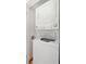 A new, white, stackable washer and dryer in a utility closet at 32 Tradd St, Charleston, SC 29401