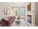 Formal living room with fireplace, chandelier, and bright natural light at 32 Tradd St, Charleston, SC 29401