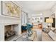 Bright living room with fireplace, hardwood floors, and view to the kitchen at 32 Tradd St, Charleston, SC 29401