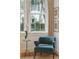 Bright accent chair is paired with a small table and framed artwork in the living room at 32 Tradd St, Charleston, SC 29401
