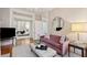 Elegant living room features hardwood floors, a plush sofa, and an inviting view into the bedroom at 32 Tradd St, Charleston, SC 29401