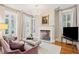 Living room with fireplace, chandelier, hardwood flooring and french doors at 32 Tradd St, Charleston, SC 29401