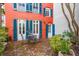 Charming patio with brick flooring and bright red exterior, perfect for outdoor entertaining at 32 Tradd St, Charleston, SC 29401