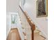 Hallway staircase with carpet runner and hardwood flooring to exterior door at 32 Tradd St, Charleston, SC 29401