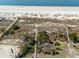 Stunning aerial view of a pristine beach with multiple wooden walkways leading to the sandy shore at 3408 Palmetto Blvd, Edisto Island, SC 29438