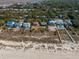 Beachfront homes with private walkways and mature landscaping, aerial view at 3408 Palmetto Blvd, Edisto Island, SC 29438