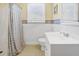 Clean bathroom with a shower/tub, white tiled walls, and a white sink at 3408 Palmetto Blvd, Edisto Island, SC 29438