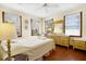 Cozy bedroom features hardwood floors, three windows, and a vanity with a mirror at 3408 Palmetto Blvd, Edisto Island, SC 29438