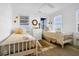 Bright bedroom features two twin beds, white walls, and natural light from two windows at 3408 Palmetto Blvd, Edisto Island, SC 29438