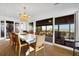 Bright dining room with a chandelier and sliding glass doors leading to an outdoor deck with an ocean view at 3408 Palmetto Blvd, Edisto Island, SC 29438