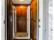 Elevator with wooden panels and a metal accordion door at 3408 Palmetto Blvd, Edisto Island, SC 29438