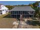Charming beach house with screened porch, wooden walkway and stairs leading to the entrance at 3408 Palmetto Blvd, Edisto Island, SC 29438