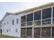 Exterior view of a multi-story home with screened in porches on the waterfront at 3408 Palmetto Blvd, Edisto Island, SC 29438