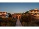 Exterior view of a beach community home with a wooden walkway at 3408 Palmetto Blvd, Edisto Island, SC 29438