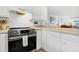 Modern kitchen featuring stainless steel appliances, white cabinets, and functional countertops at 3408 Palmetto Blvd, Edisto Island, SC 29438