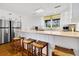 Bright kitchen with white cabinets, stainless steel appliances, and a breakfast bar with seating at 3408 Palmetto Blvd, Edisto Island, SC 29438