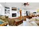 Inviting living room features a brick fireplace, built-in shelving, and wood floors at 3408 Palmetto Blvd, Edisto Island, SC 29438